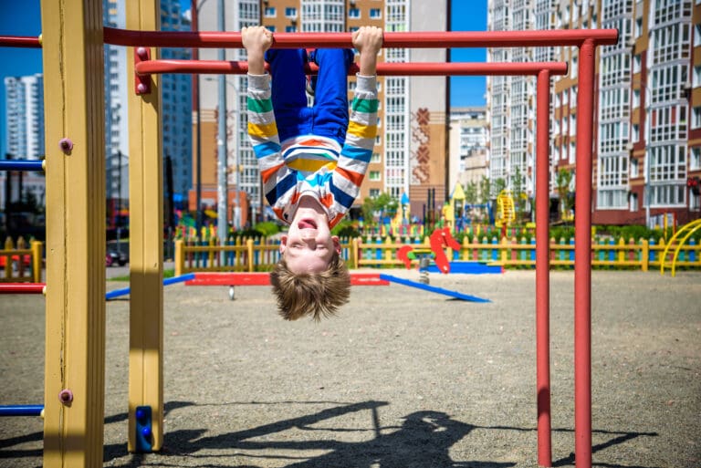 Kid playing in a plaground in an urban sitting