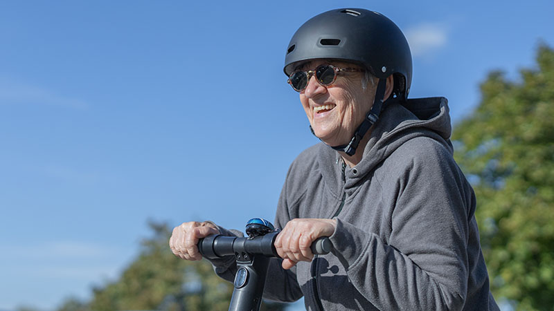 elderly woman riding an electric scooter