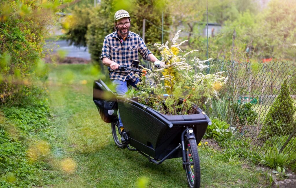 Gardener using a carg bike to carry his plants