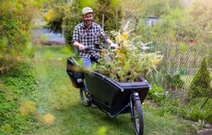 Gardener using a carg bike to carry his plants