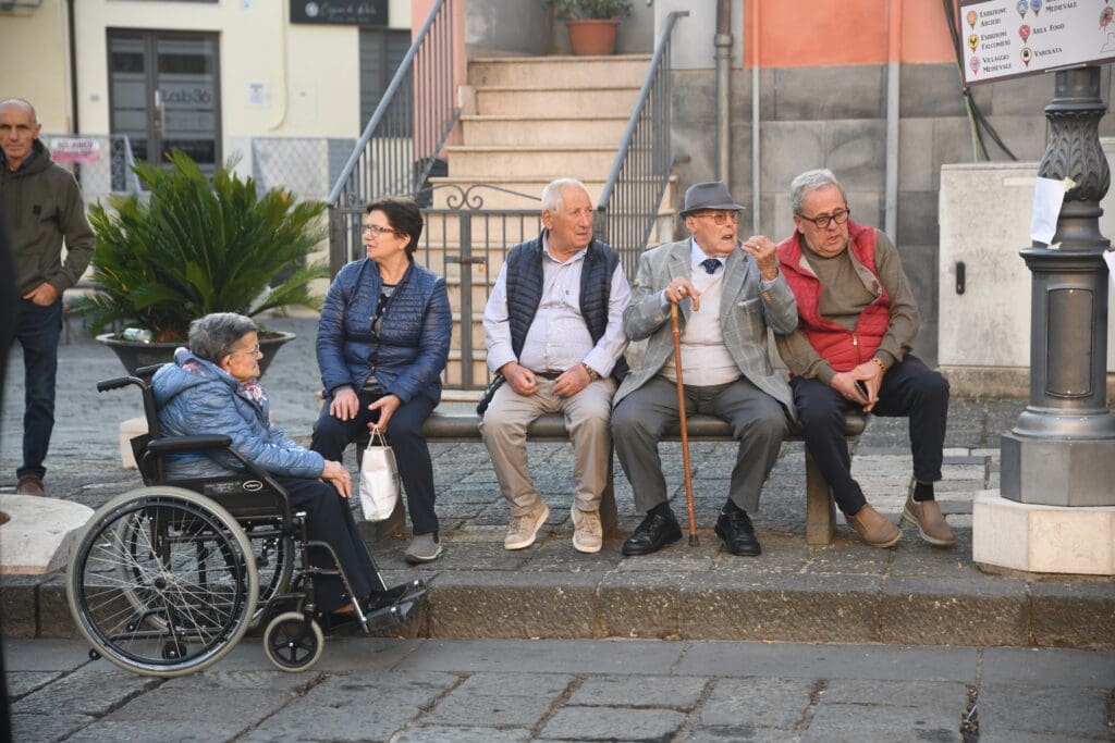 A group of elderly people at a bus stop
