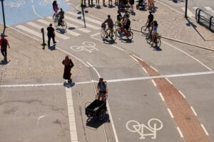 People cycling at a buy cross road
